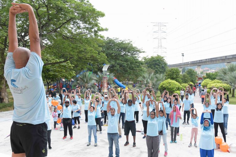 QI Staff participate in “Umbrella Walk” to raise awareness on the topic of child sexual abuse