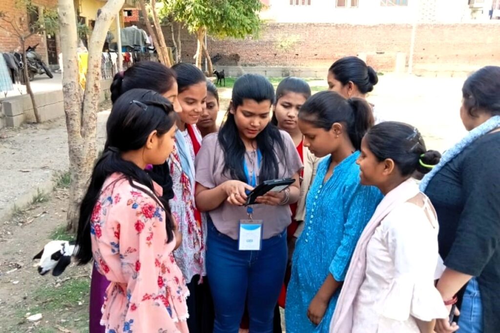 A group of girls surrounds a women’s safety advocate.