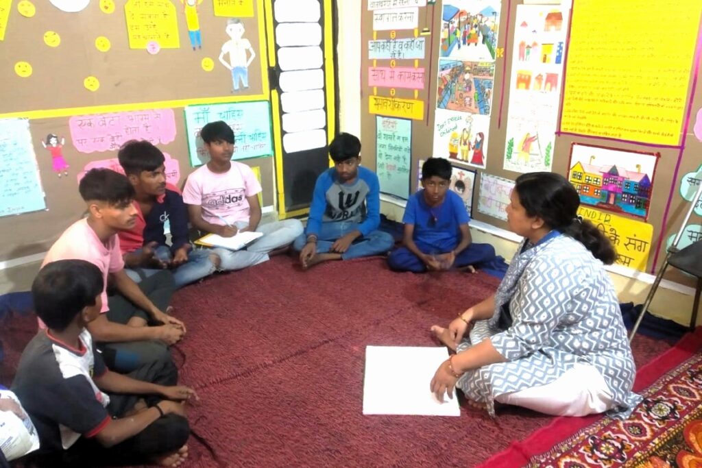 A women’s safety leader teaches young boys in the classroom.
