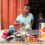 A hearing-impaired shoemaker in Ghana working at his workshop.