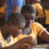 Two youths with disabilities in a Ghanaian classroom focused intently on their studies.
