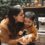 Autism in Malaysia: A mother kisses her child’s head in a kitchen, showing love and acceptance.