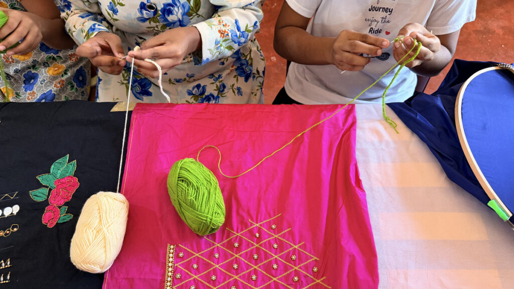 Children taking part in a sewing activity at the Safe Home